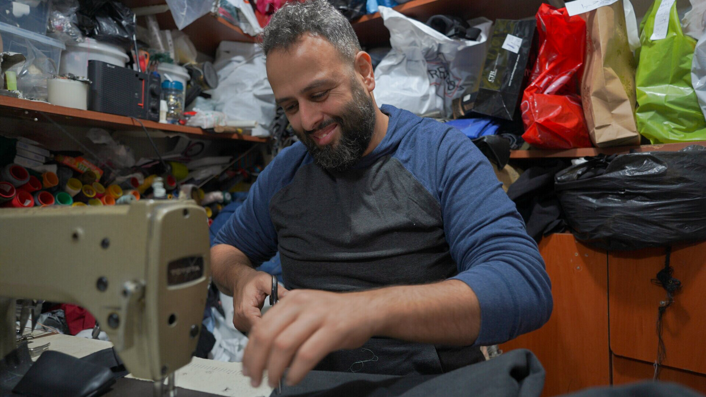 Tailor Ibrahim works on his sewing machine