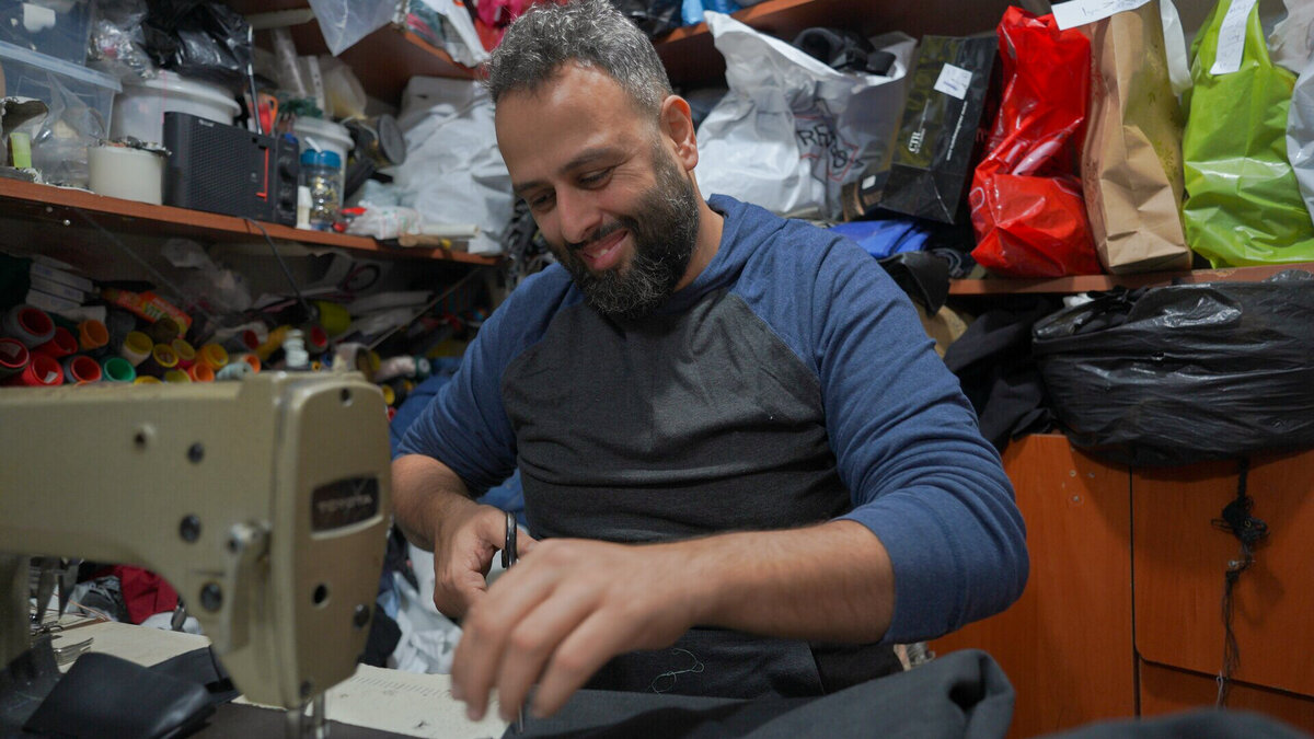Tailor Ibrahim works on his sewing machine
