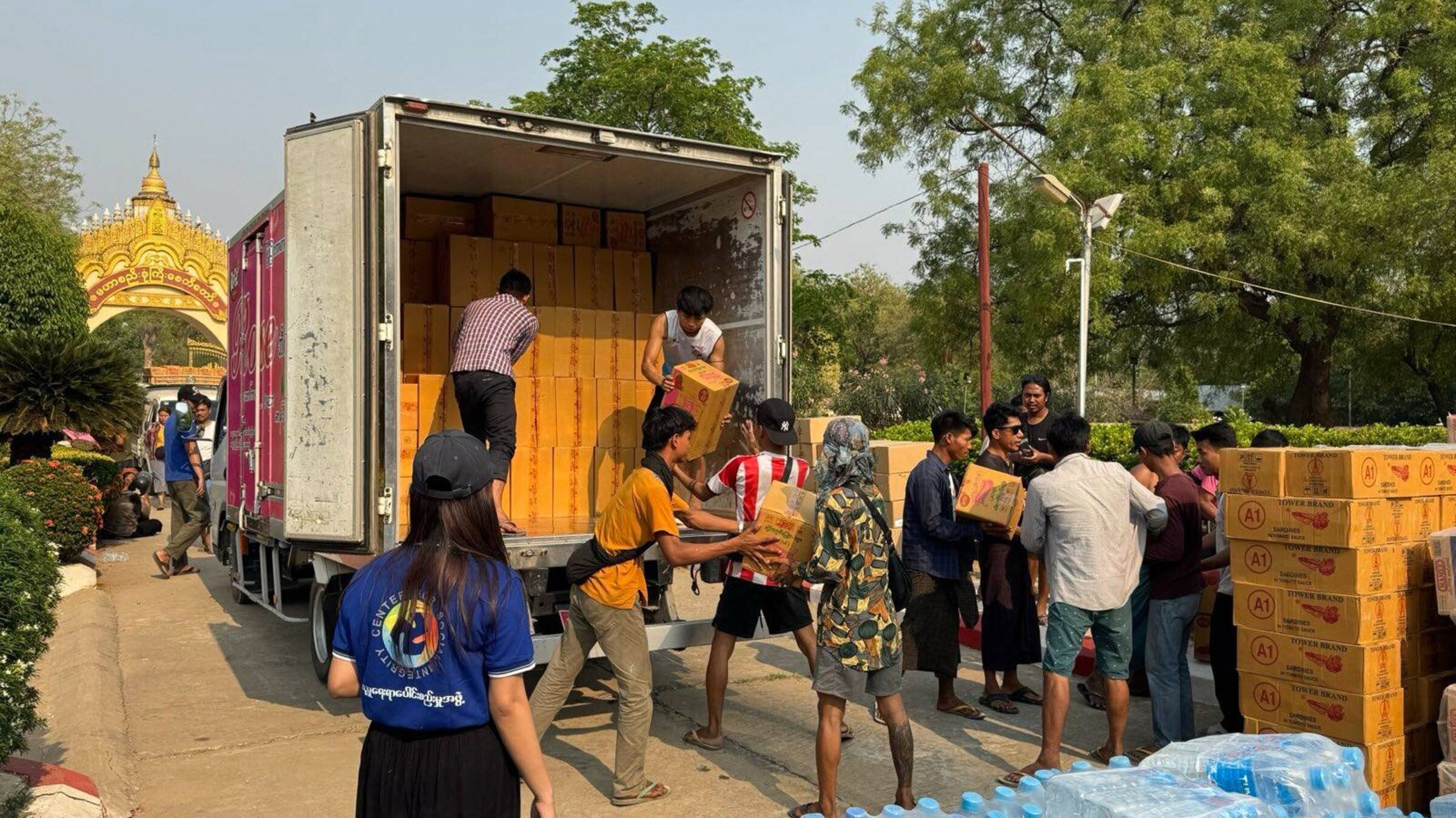 Helpers unload a truck with relief supplies