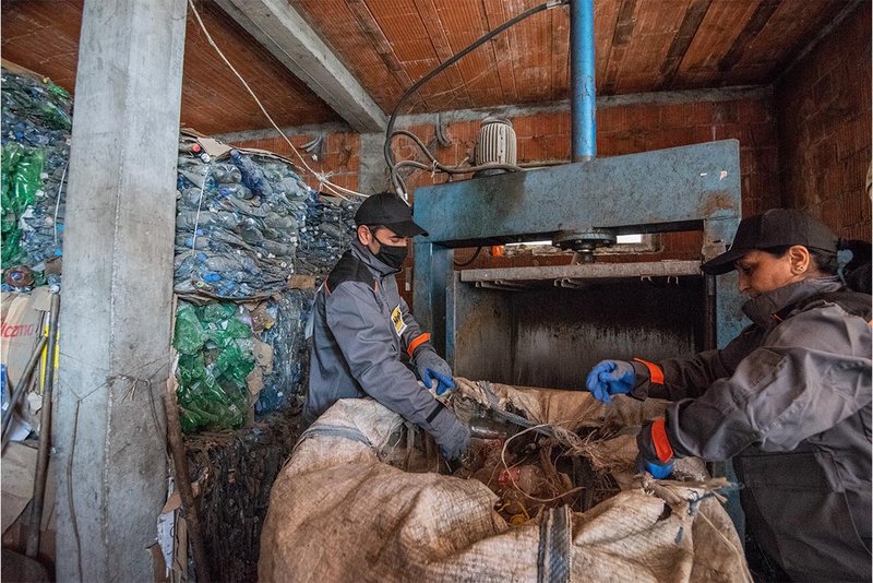 Zwei Menschen vor einer Recyclingmaschine