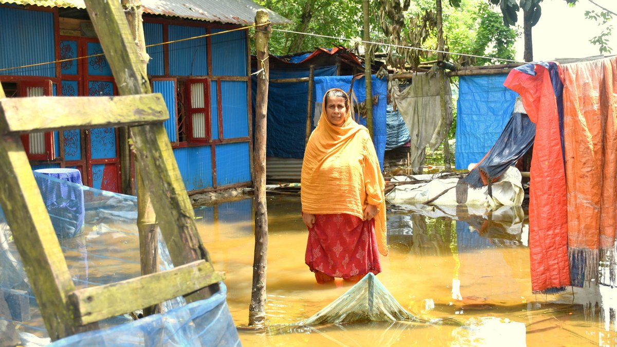 Schwere Überschwemmungen in Bangladesch Eine Frau steht vor ihrem überfluteten Haus