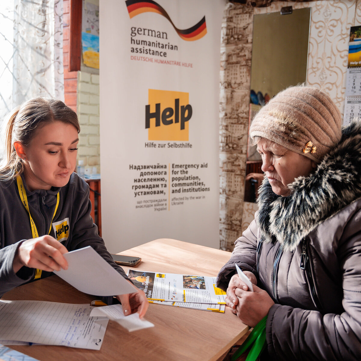A humanitarian aid worker in conversation with a Ukrainian lady