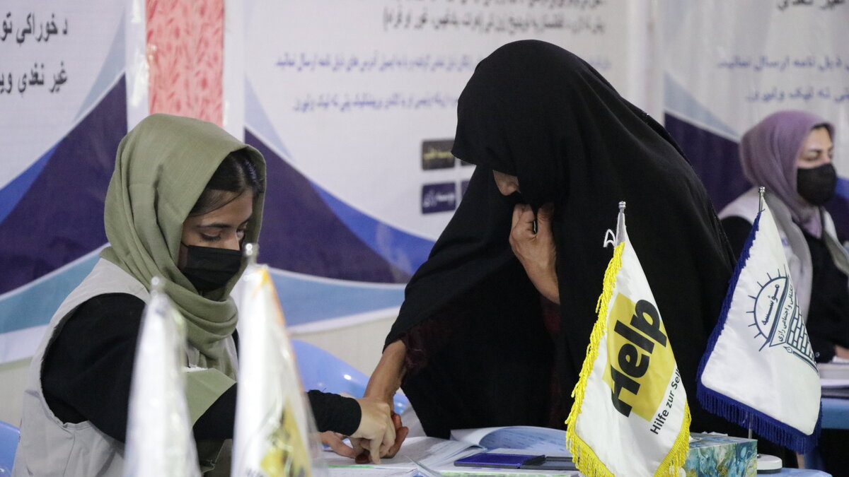 An Afghan woman is registered for aid.