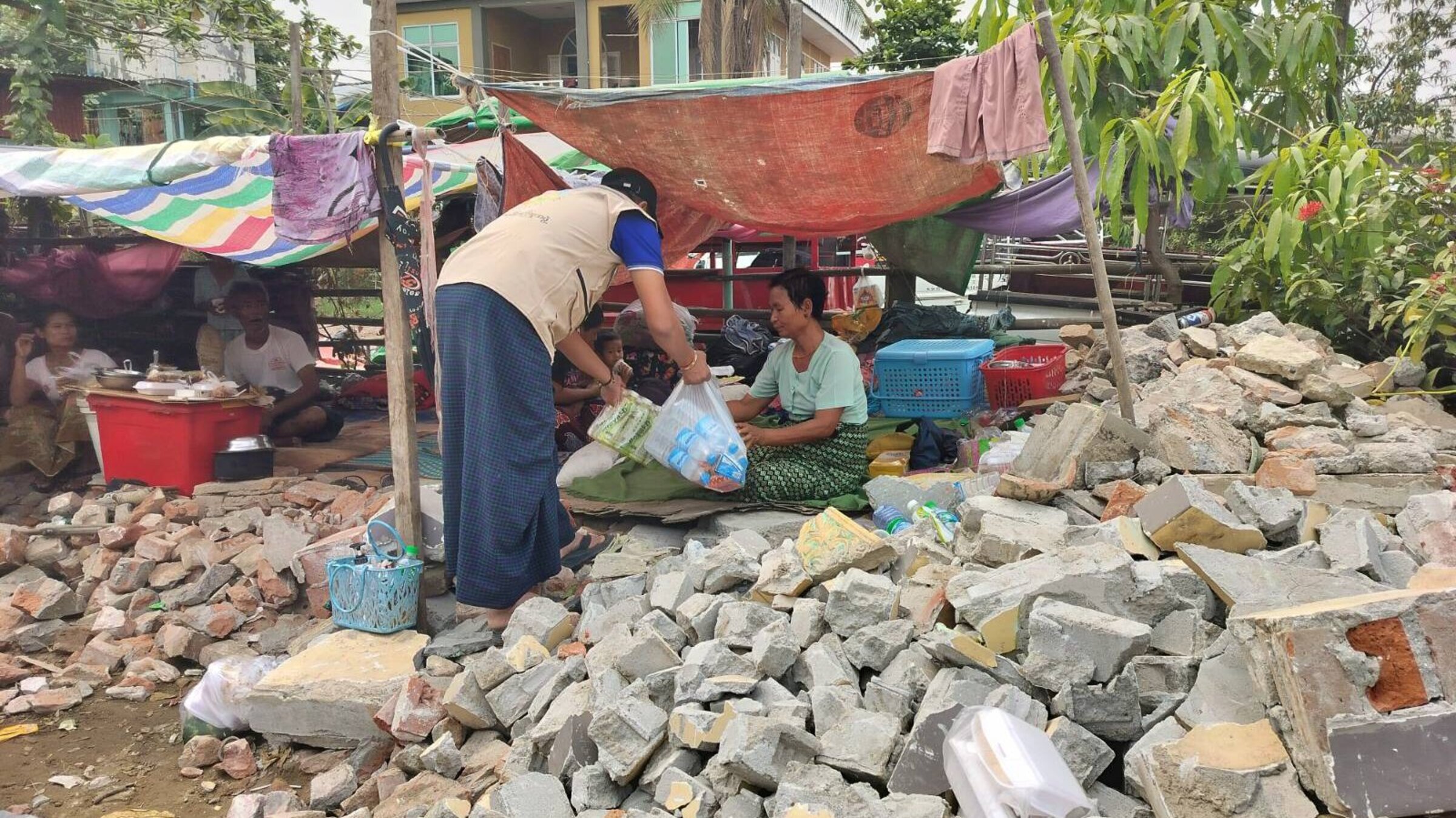 An aid worker cares for people left homeless by the earthquake in Myanmar
