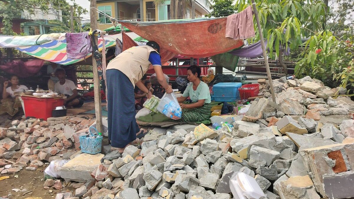 An aid worker cares for people left homeless by the earthquake in Myanmar