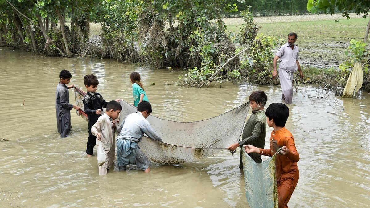 Kinder mit Fischernetz im Fluss