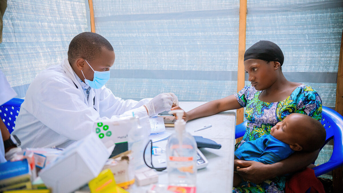  A doctor treats a mother and her child