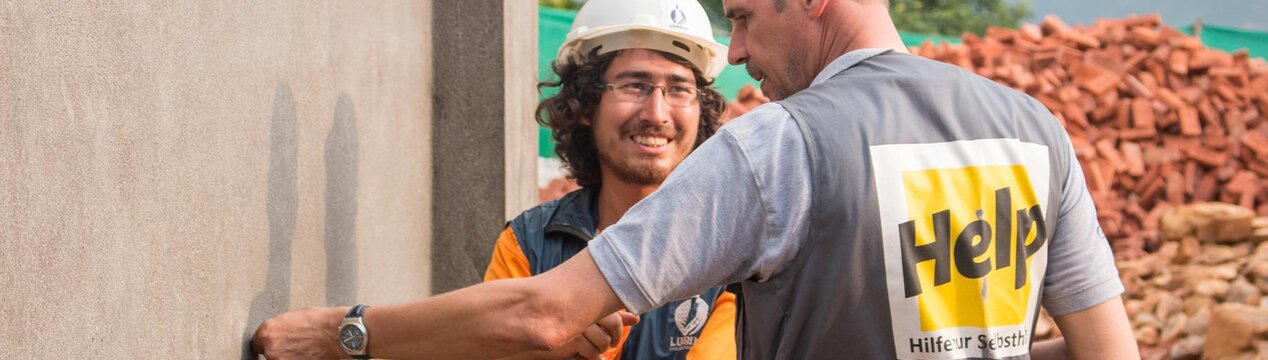 Zwei Help-Mitarbeiter bei der Kontrolle eines Neubaus